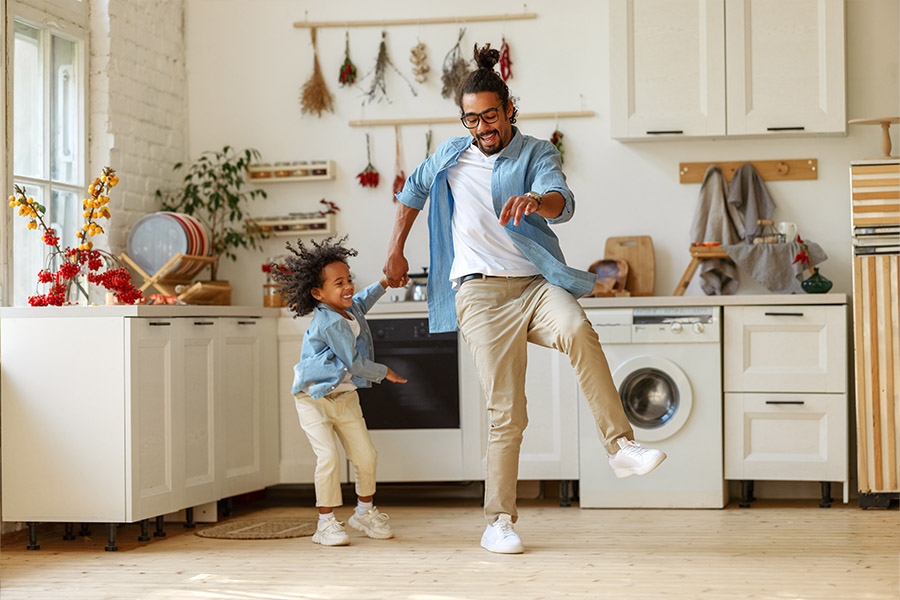 Personal Insurance - Father Dancing with His Child in the Kitchen